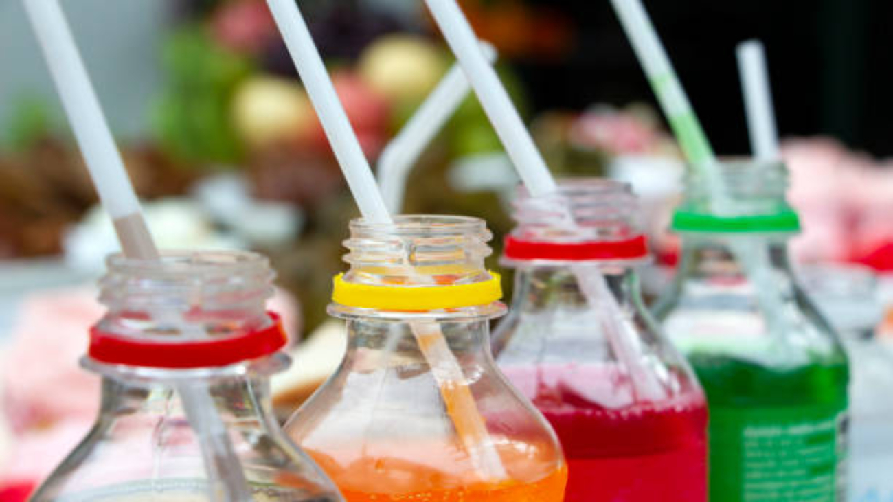 Colorful of carbonated soft drink pop soda bottles with plastic straw. Plastic bottles of assorted carbonated in variety of colors.